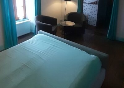 Double bed and seating area in room Himalaya